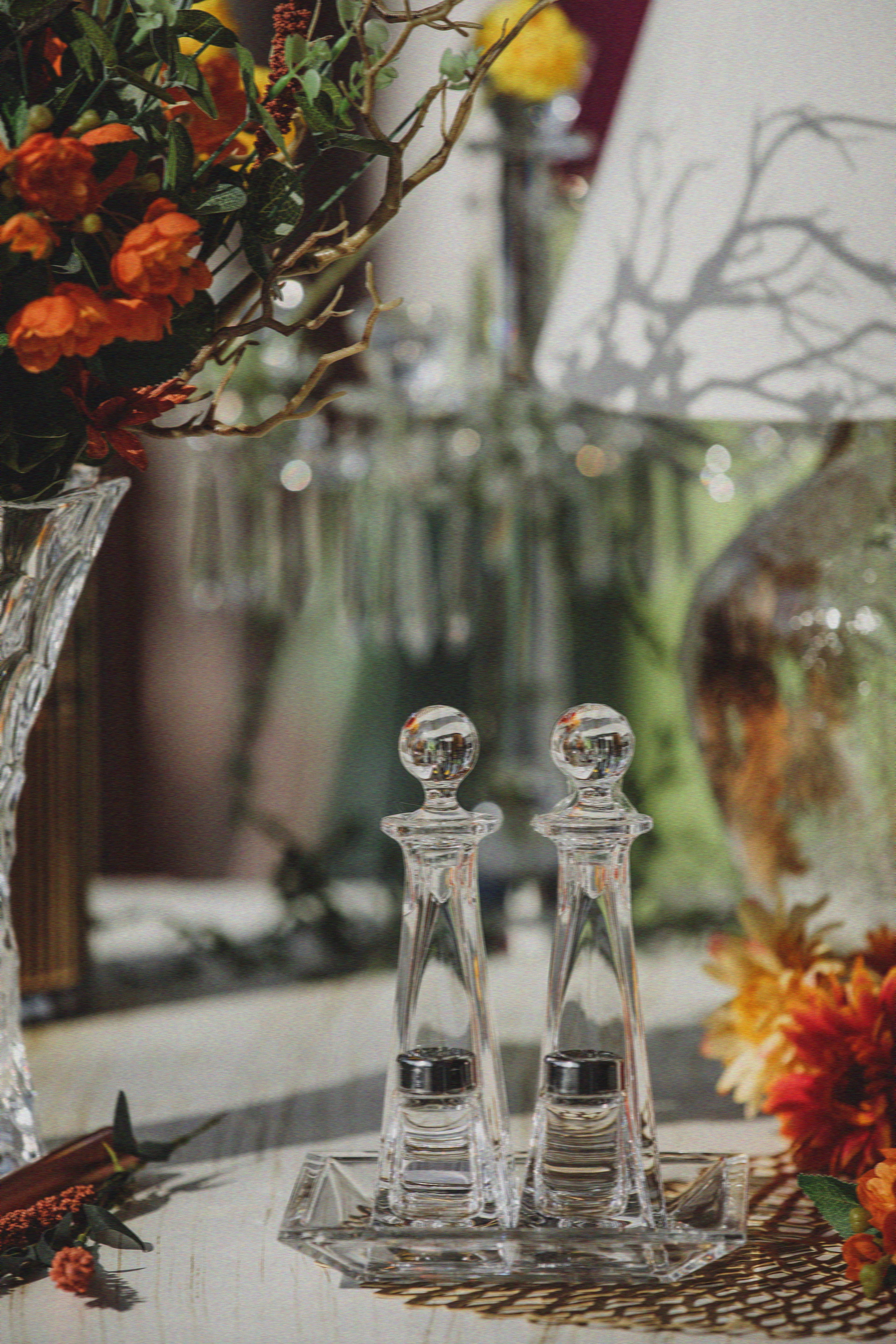 An intimately lit table set with crystal glassware and refined cutlery